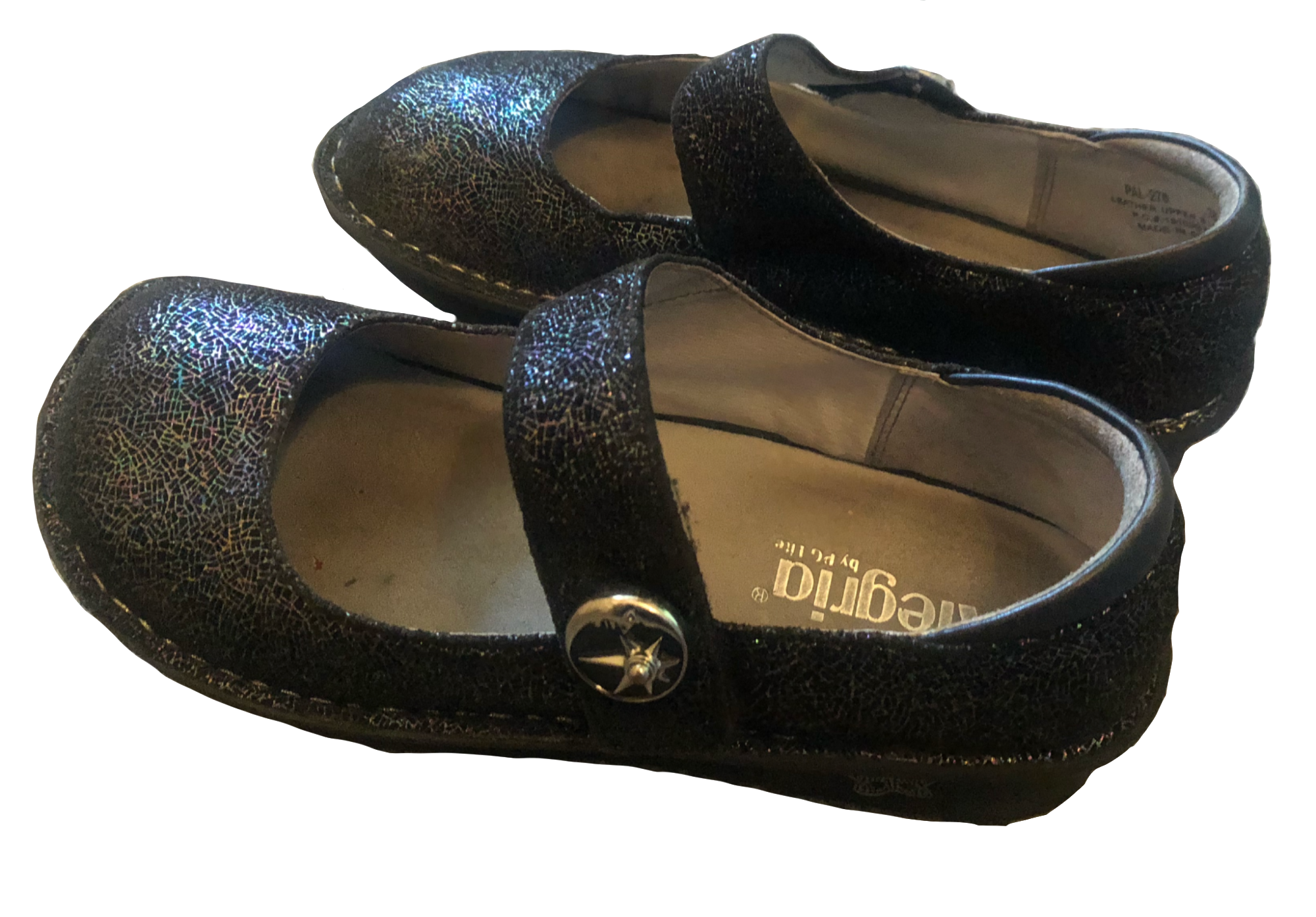 A pair of dark sparkled mary janes from Alegria. They have velcro straps, with a sun and moon charm.