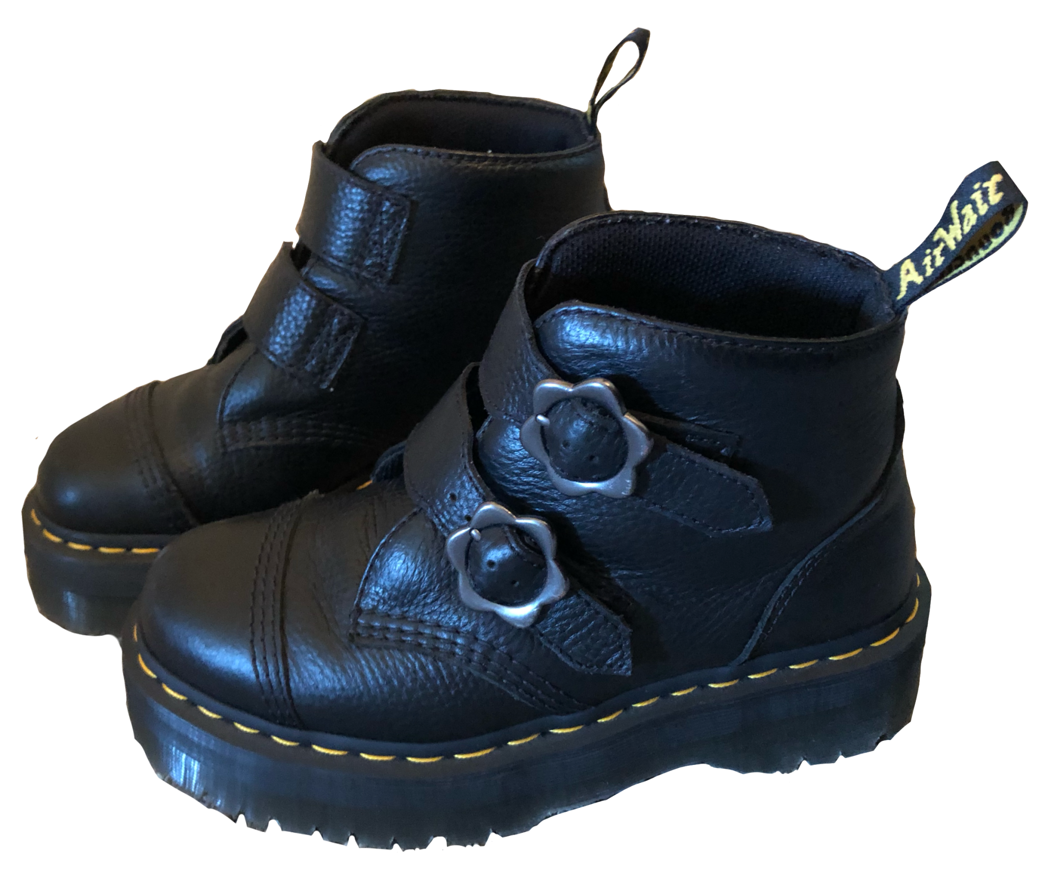 A pair of black boots with flower buckles from Doc Martens